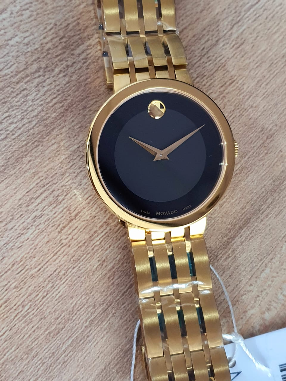 Movado gold watch black clearance face